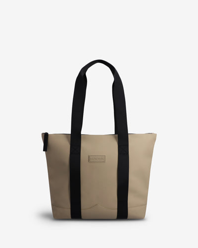 A beige tote bag with black shoulder straps and a small rectangular 'Hunter' brand plaque on the front, photographed against a clean white background.