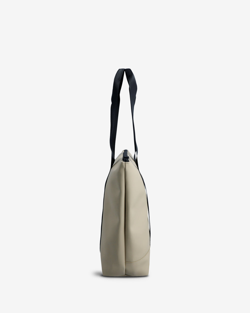 A side profile view of a beige tote bag with a black shoulder strap, shown against a plain light gray background.
