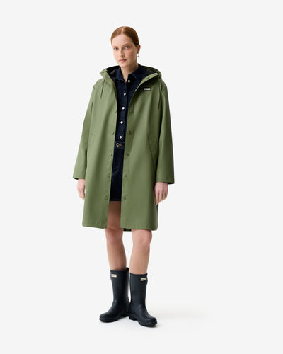 Displays a model wearing the Olive Ellis 'Hunter' branded Women's Olive Ellis PU Raincoat