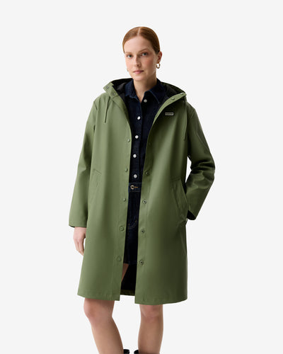 Displays a model wearing the Olive Ellis 'Hunter' branded Women's Olive Ellis PU Raincoat