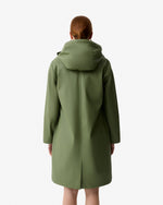 Displays a model wearing the Olive Ellis 'Hunter' branded Women's Olive Ellis PU Raincoat