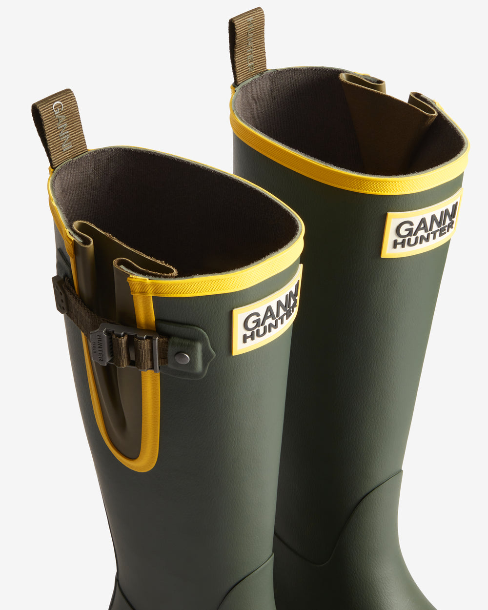 Displays a pair of the Dark Olive 'Hunter' branded Unisex GANNI X Hunter Tall Adjustable Downpour Wellington Boots