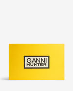 Displays the packaging of the Leopard 'Hunter' branded unisex Leopard GANNI X Hunter Tall Adjustable Downpour Wellington Boot