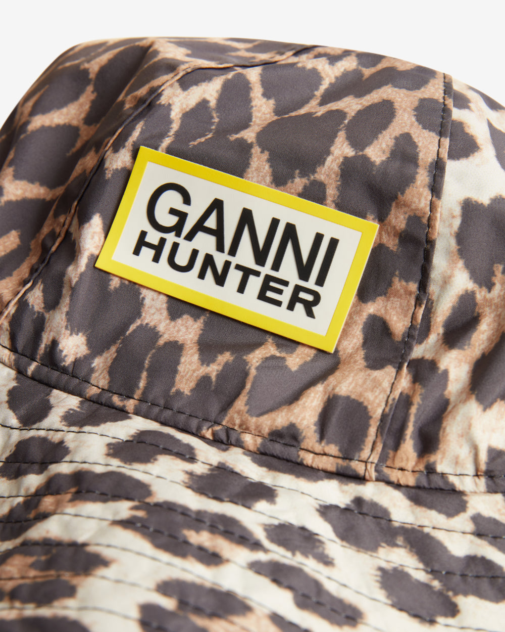 Displays the Leopard 'Hunter' branded unisex GANNI X Hunter Waterproof Bucket Hat featuring the Ganni x Hunter logo