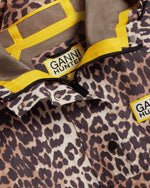 Displays the Leopard 'Hunter' branded unisex GANNI X Hunter Waterproof Poncho featuring the details including the Ganni x Hunter branding 