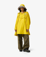 Displays a model wearing the Lemon 'Hunter' branded Unisex Ganni X Hunter Waterproof Poncho 