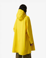 Displays a model wearing the Lemon 'Hunter' branded Unisex Ganni X Hunter Waterproof Poncho
