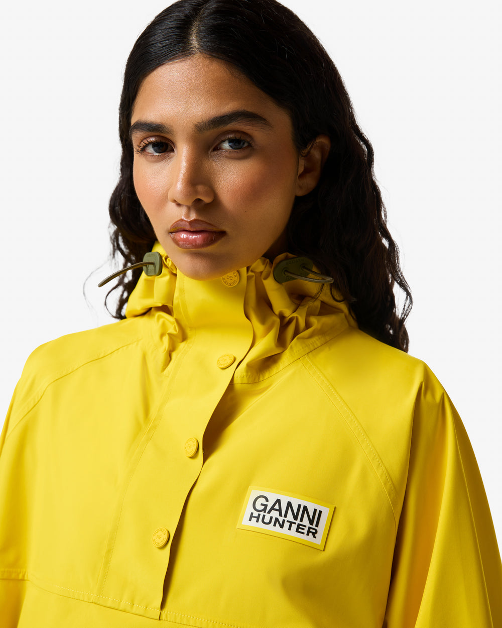 Displays a model wearing the Lemon 'Hunter' branded Unisex Ganni X Hunter Waterproof Poncho