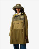 Displays a model wearing the Green 'Hunter' branded Unisex GANNI X Hunter Waterproof Poncho