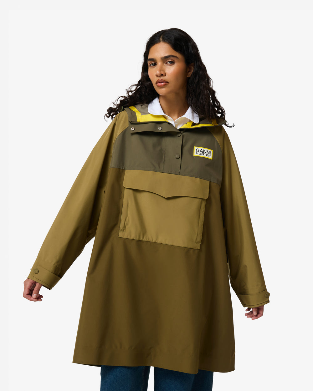 Displays a model wearing the Green 'Hunter' branded Unisex GANNI X Hunter Waterproof Poncho