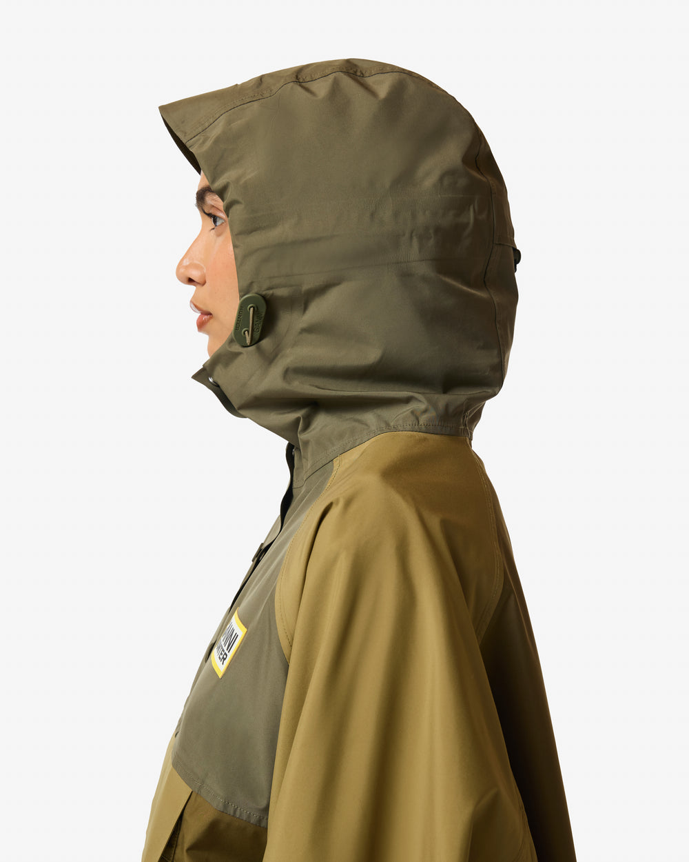 Displays a model wearing the Green 'Hunter' branded Unisex GANNI X Hunter Waterproof Poncho