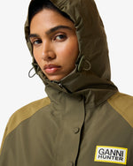 Displays a model wearing the Green 'Hunter' branded Unisex GANNI X Hunter Waterproof Poncho