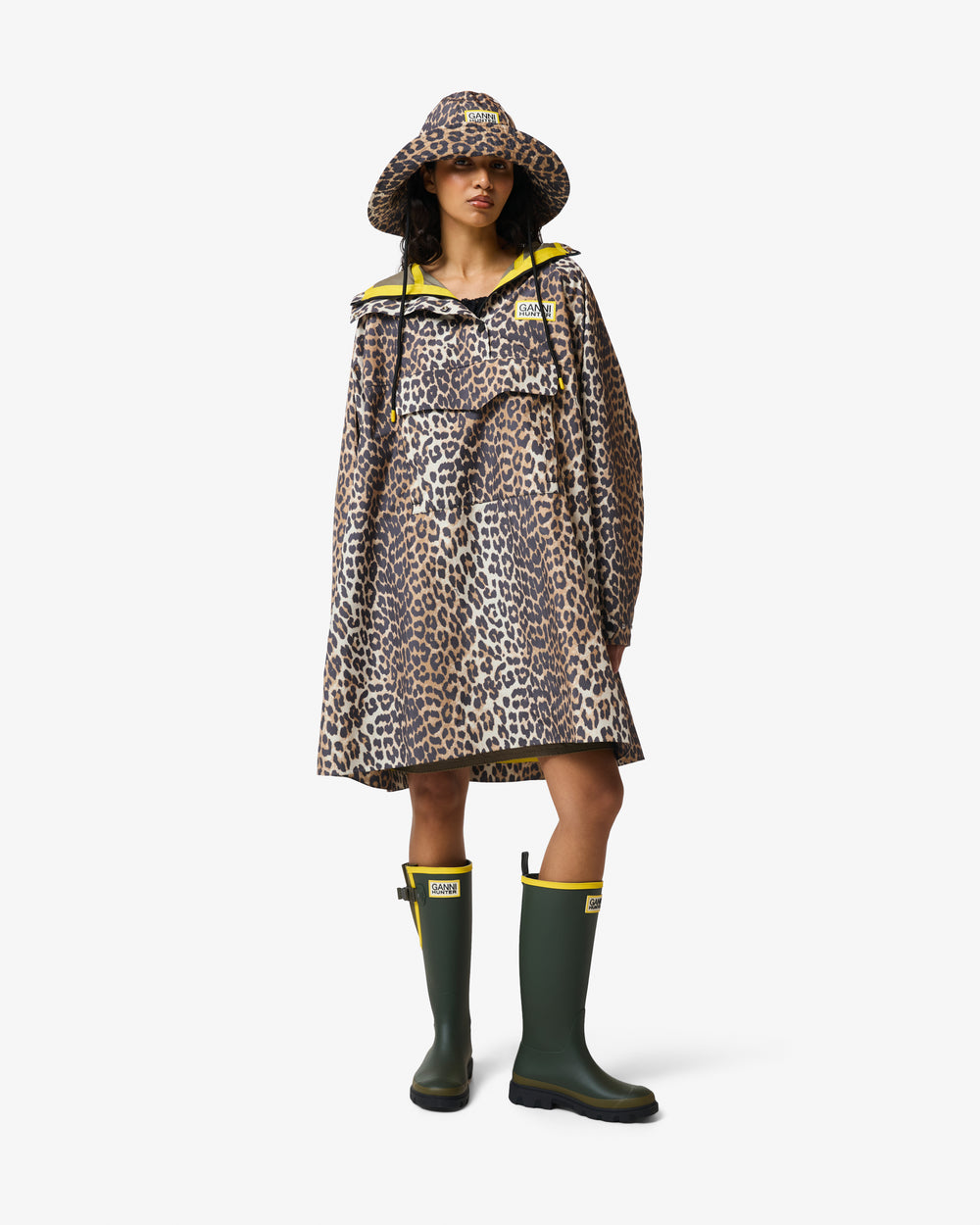 Displays a model wearing the Leopard 'Hunter' branded unisex GANNI X Hunter Waterproof Poncho