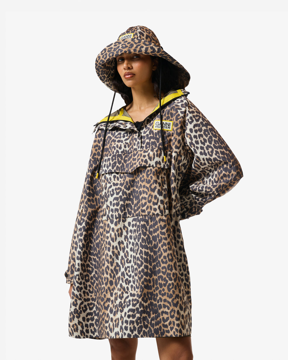 Displays a model wearing the Leopard 'Hunter' branded unisex GANNI X Hunter Waterproof Poncho