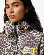 Displays a model wearing the Leopard 'Hunter' branded unisex GANNI X Hunter Waterproof Poncho
