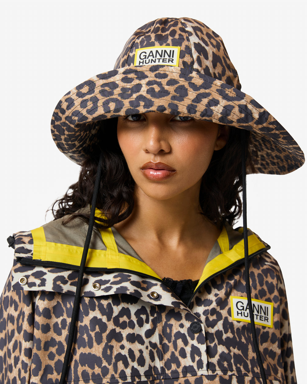 Displays a model wearing the Leopard 'Hunter' branded unisex GANNI X Hunter Waterproof Bucket Hat
