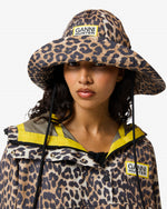 Displays a model wearing the Leopard 'Hunter' branded unisex GANNI X Hunter Waterproof Poncho