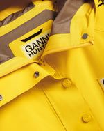 Displays the Lemon 'Hunter' branded Unisex Ganni X Hunter Waterproof Poncho featuring the details including the Ganni x Hunter logo branding 