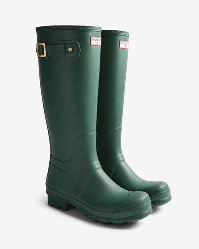 Pair of green Hunter rain boots on a white background