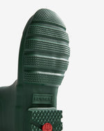 Close-up of a green Hunter boot sole on a light gray background