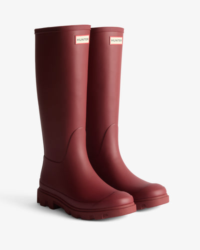 Displays a pair of the Red 'Hunter' branded Unisex Downpour Tall Wellington Boots