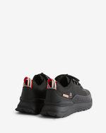 A pair of black Hunter sneakers shown from a rear three-quarter angle against a clean white background. The shoes feature black mesh and synthetic uppers, thick black soles, and red and white pull tabs on the heel.