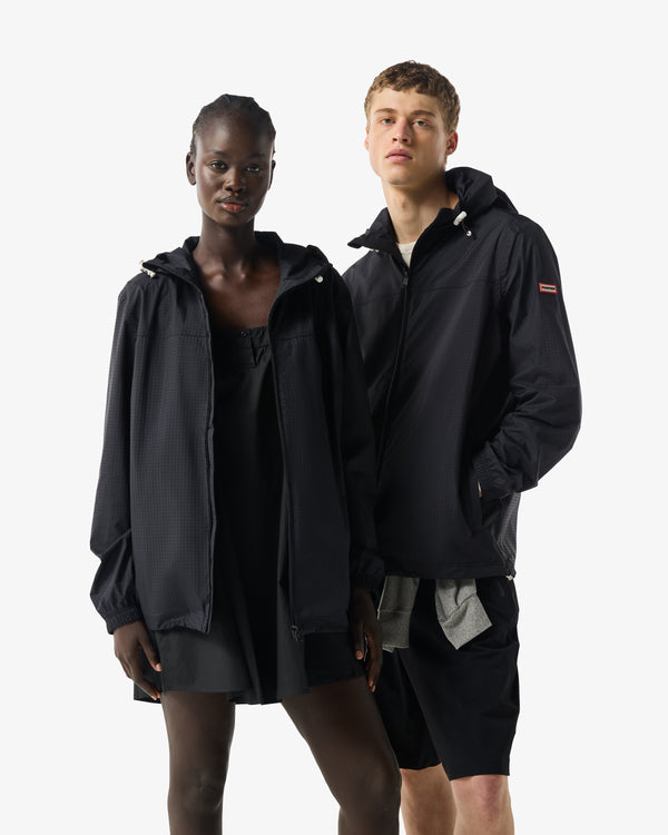 Displays two model wearing black 'Hunter' branded Unisex Play Packable Shell Rain Jacket
