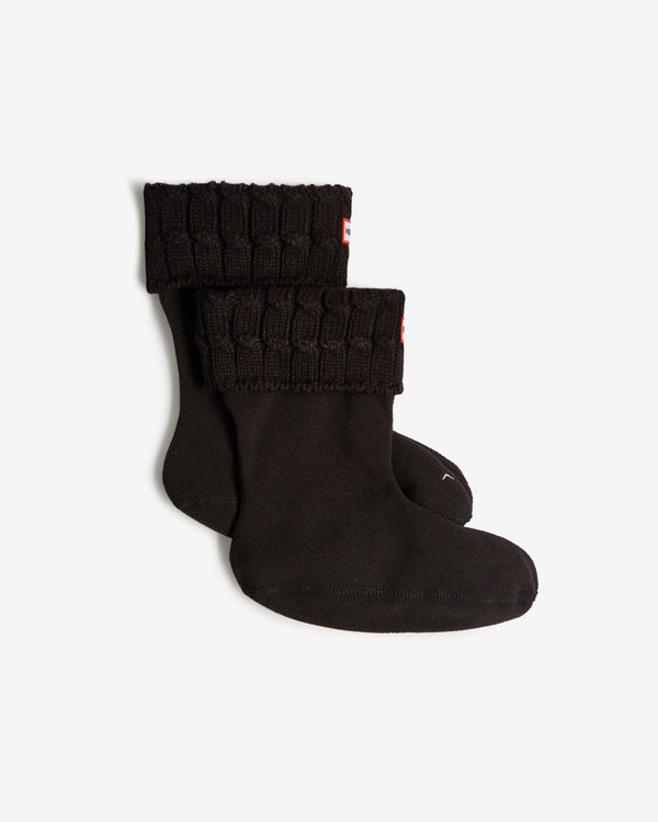 Displays a pair of black 'Hunter' branded Recycled 6 Stitch Cable Cuff Short Boot Socks