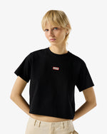 Displays a model wearing Black 'Hunter' branded Women's Essentials Logo Boxy Cropped T-Shirt