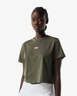 Displays a model wearing the Kambaba Green 'Hunter' branded Women's Essentials Logo Boxy Cropped T-Shirt