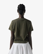 Displays a model wearing the Kambaba Green 'Hunter' branded Women's Essentials Logo Boxy Cropped T-Shirt