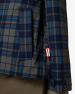 Displays a model wearing the kambaba 'Hunter' branded Women's Original Waterproof Tartan Jacket featuring the close up on the details and branding 