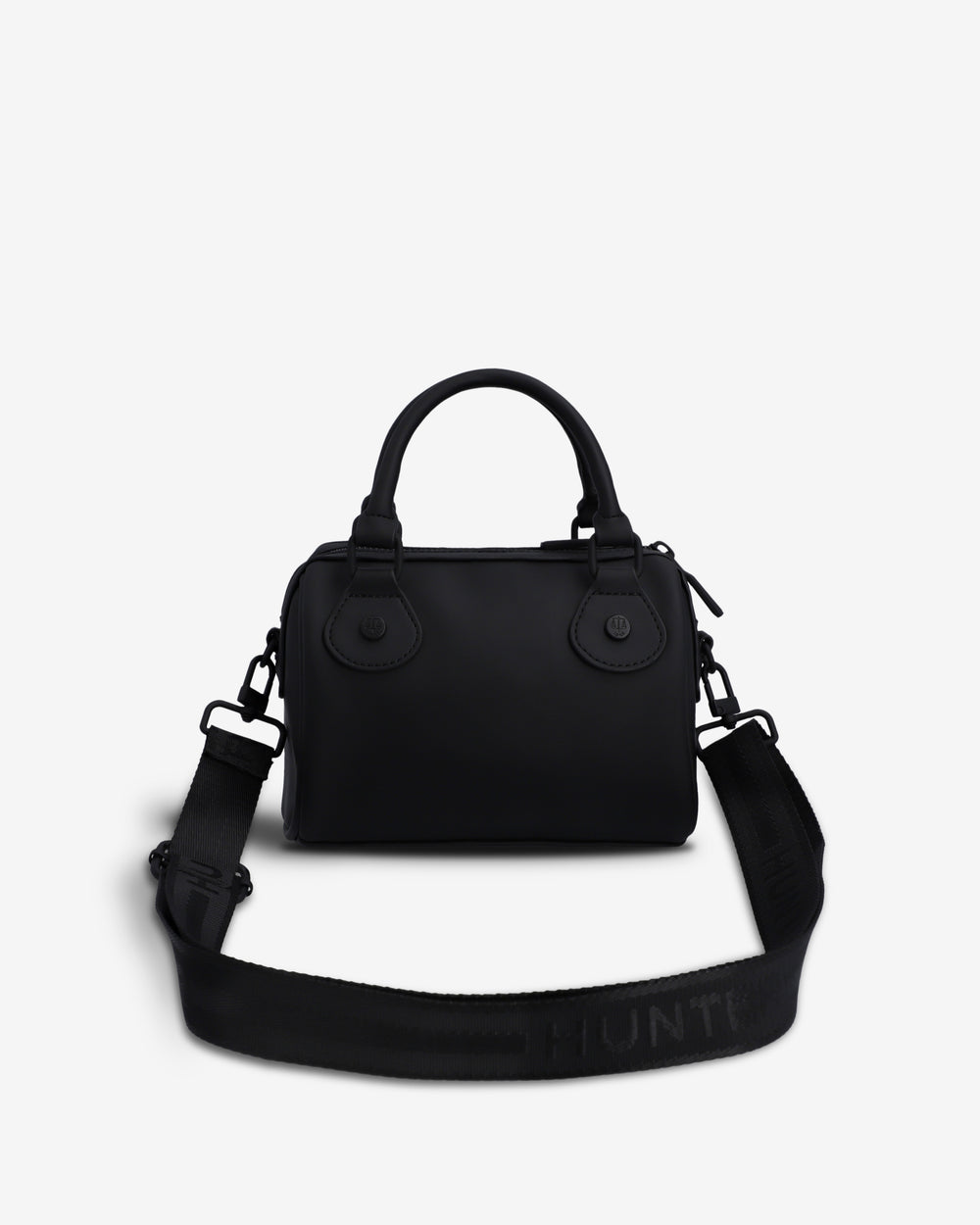 A black structured handbag with top handles and a wide matching shoulder strap, photographed on a clean light gray background. The strap has the brand name HUNTER printed in black on it.