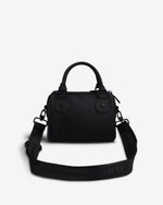 A black structured handbag with top handles and a wide matching shoulder strap, photographed on a clean light gray background. The strap has the brand name HUNTER printed in black on it.