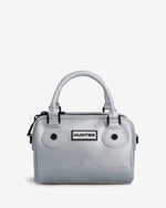 A light gray structured handbag with dual top handles, black hardware, and a central rectangular patch reading HUNTER, shown on a plain light background.
