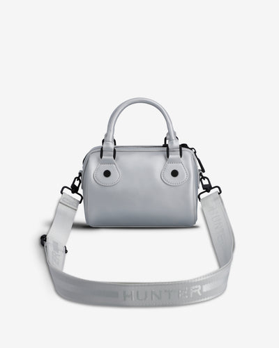 A light gray top-handle handbag with a matching shoulder strap, featuring the HUNTER brand name embossed on the strap, set against a plain light gray background.
