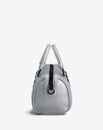 A metallic silver handbag with black hardware and a central black strap detail, photographed from the back against a clean white background.