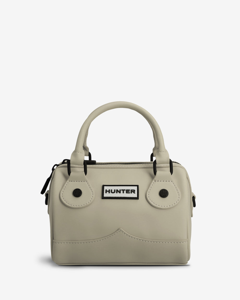 A light beige structured handbag with dual top handles, black hardware, and a white rectangular patch on the front featuring the black 'HUNTER' logo, set against a plain light gray background.