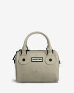 A light beige structured handbag with dual top handles, black hardware, and a white rectangular patch on the front featuring the black 'HUNTER' logo, set against a plain light gray background.