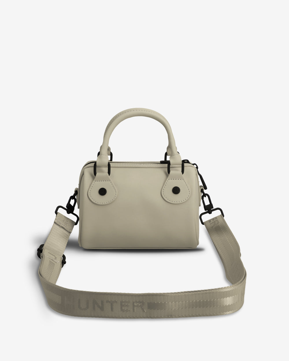 A light beige leather handbag with a top handle, double button closure, and an adjustable woven shoulder strap featuring the HUNTER logo, shown against a plain white background.