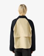 Displays a model wearing the Beige 'Hunter' branded Recrafted Cropped Jacket