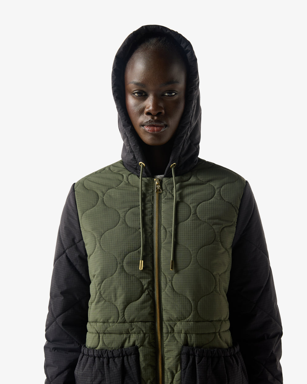 Displays a model wearing the Green 'Hunter' branded Women's Recrafted Quilted Jacket
