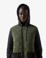 Displays a model wearing the Green 'Hunter' branded Women's Recrafted Quilted Jacket