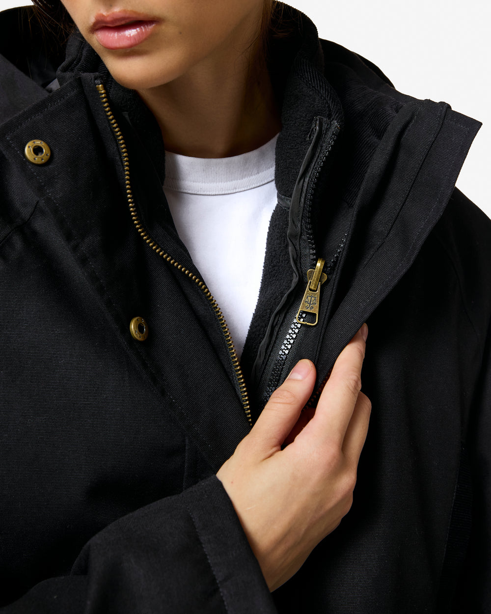 Displays a model wearing the black 'Hunter' branded Women's Original 170 Yrs Anniversary Jacket featuring the details on the inside zip